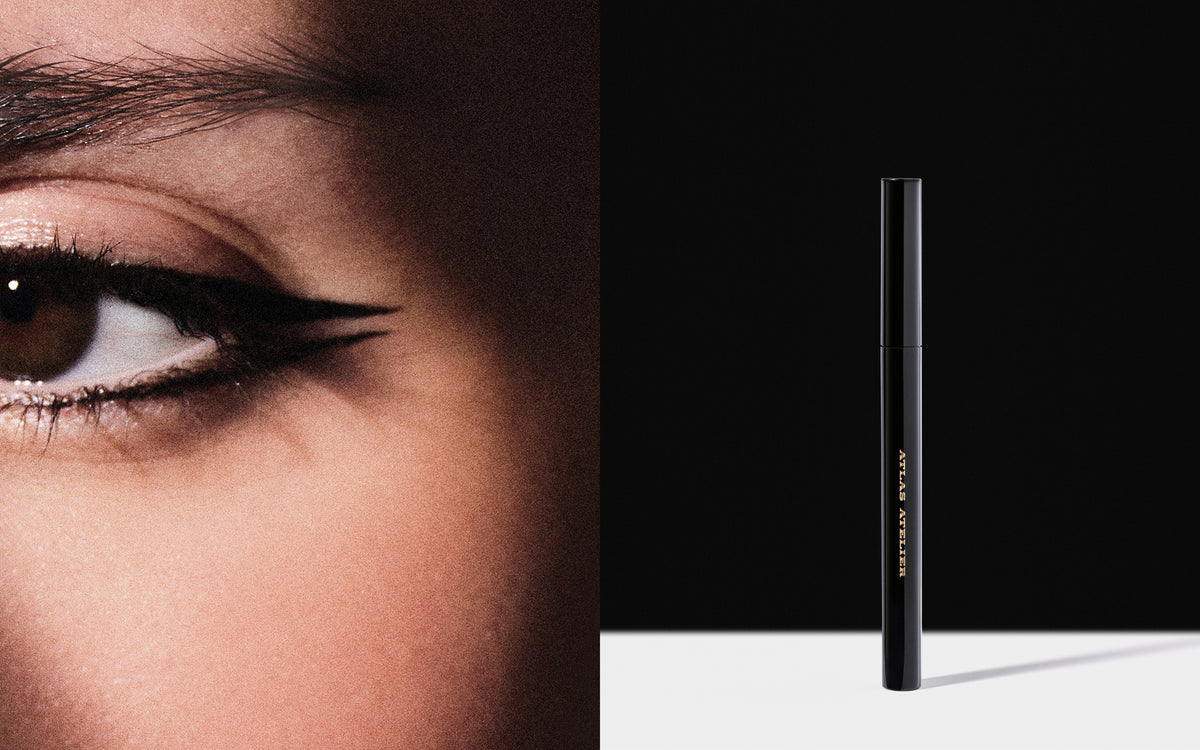 A tight photo of a woman's eye and a graphic black eyeliner
